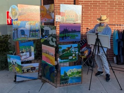 oscar will painter painting on sidewalk